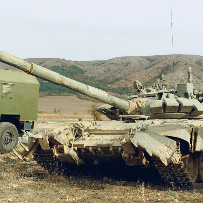 Dirty Russian battle tanks at tankodrome in mountains